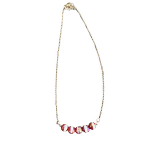 Red and white iridescent faceted beaded necklace on a gold tone chain